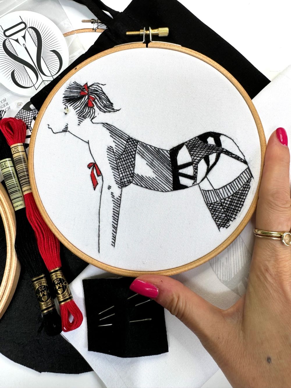 black and white embroidery kit of woman with bow in her hair