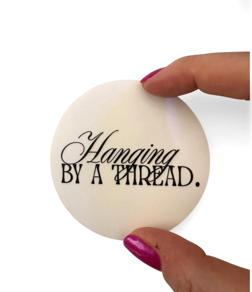 'Hanging by a Thread' Sticker
