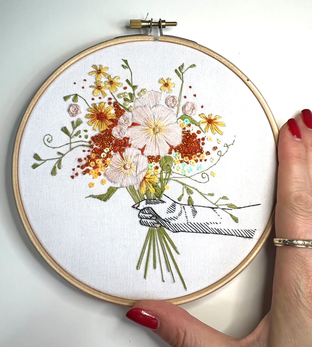 summer bouquet embroidery pattern with hand for scale