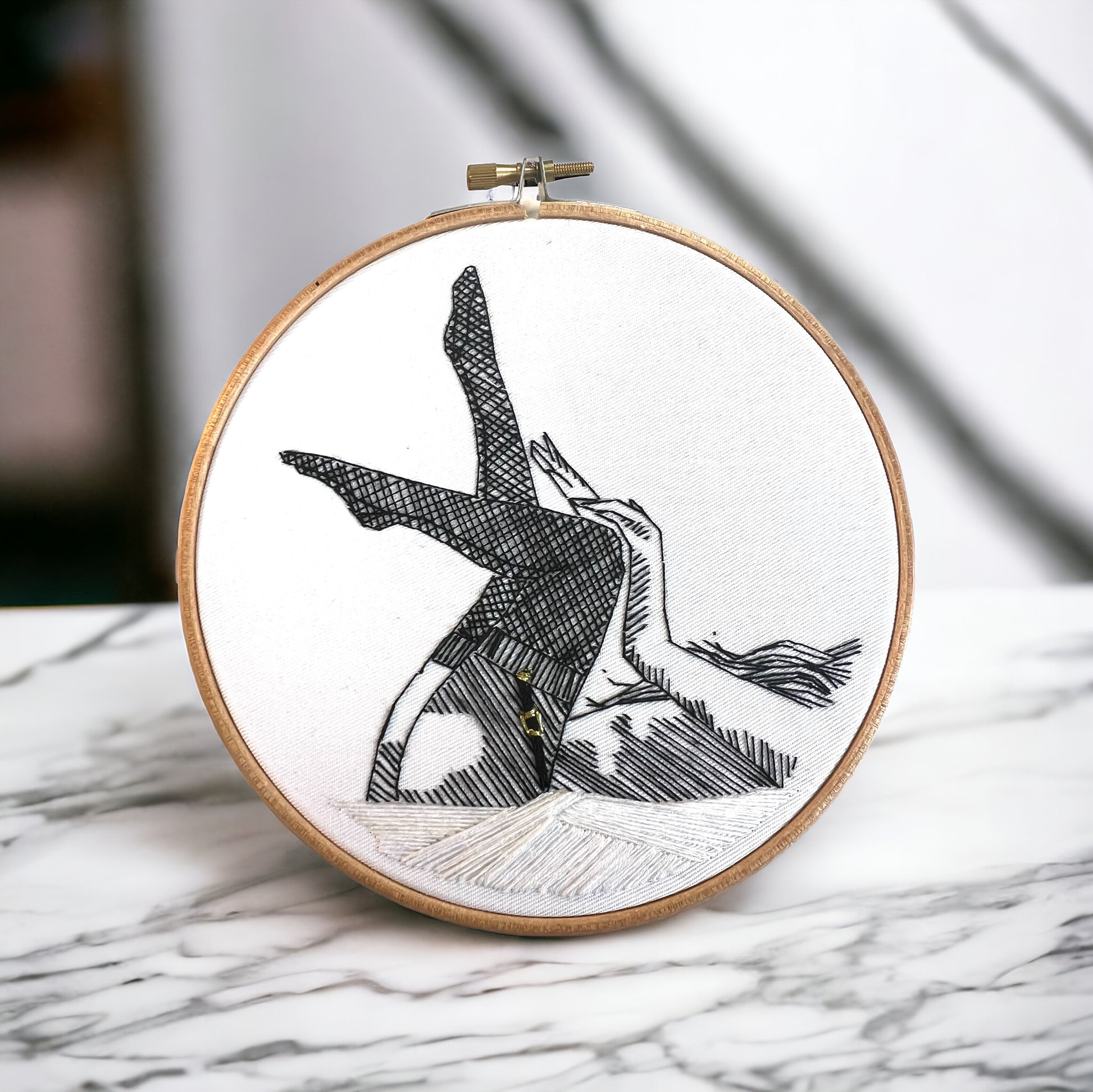 completed beginners embroidery  in 6 inch hoop of woman using black DMC embroidery thread on white cotton