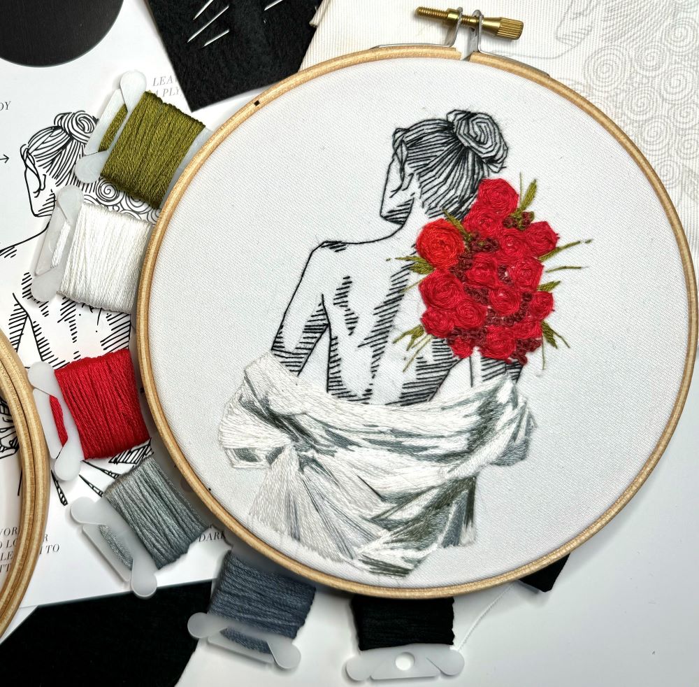 needlepoint embroidery kit of woman holding roses