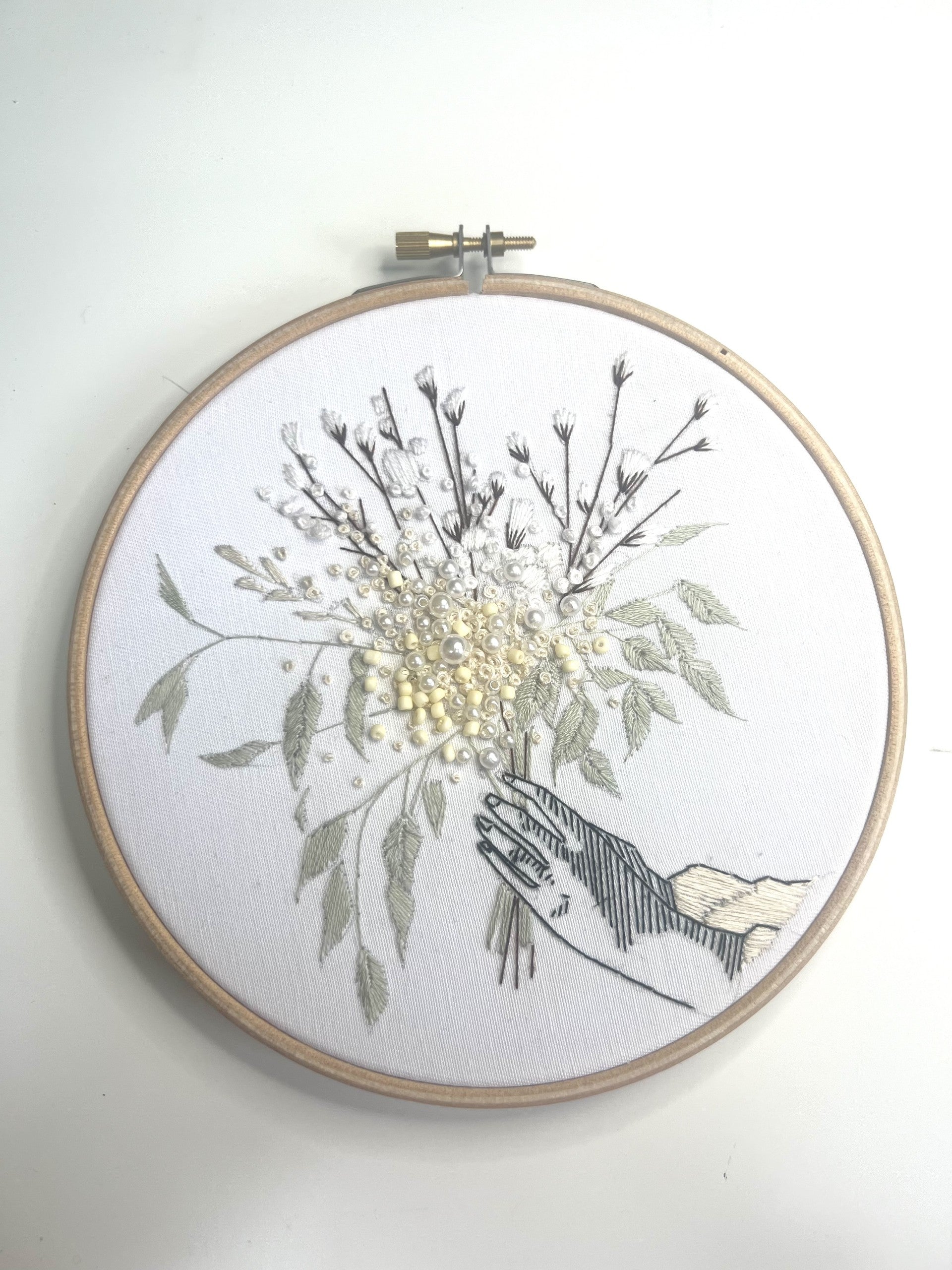 winter floral embroidery pattern against white wall